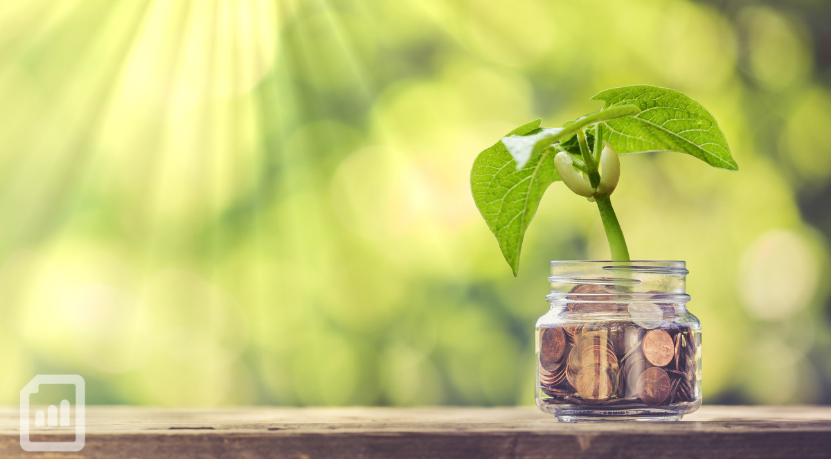 a jar filled of coins sitting outside with a plant inside