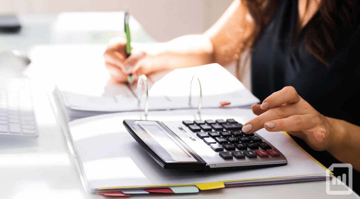 a woman using a calculator at her desk