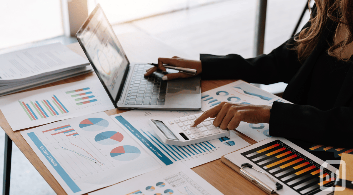 close-up of a woman reviewing financial charts at her desk